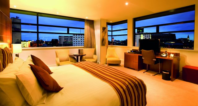 Bedroom with a panoramic view at dusk at Macdonald Manchester Hotel & Spa NCN
